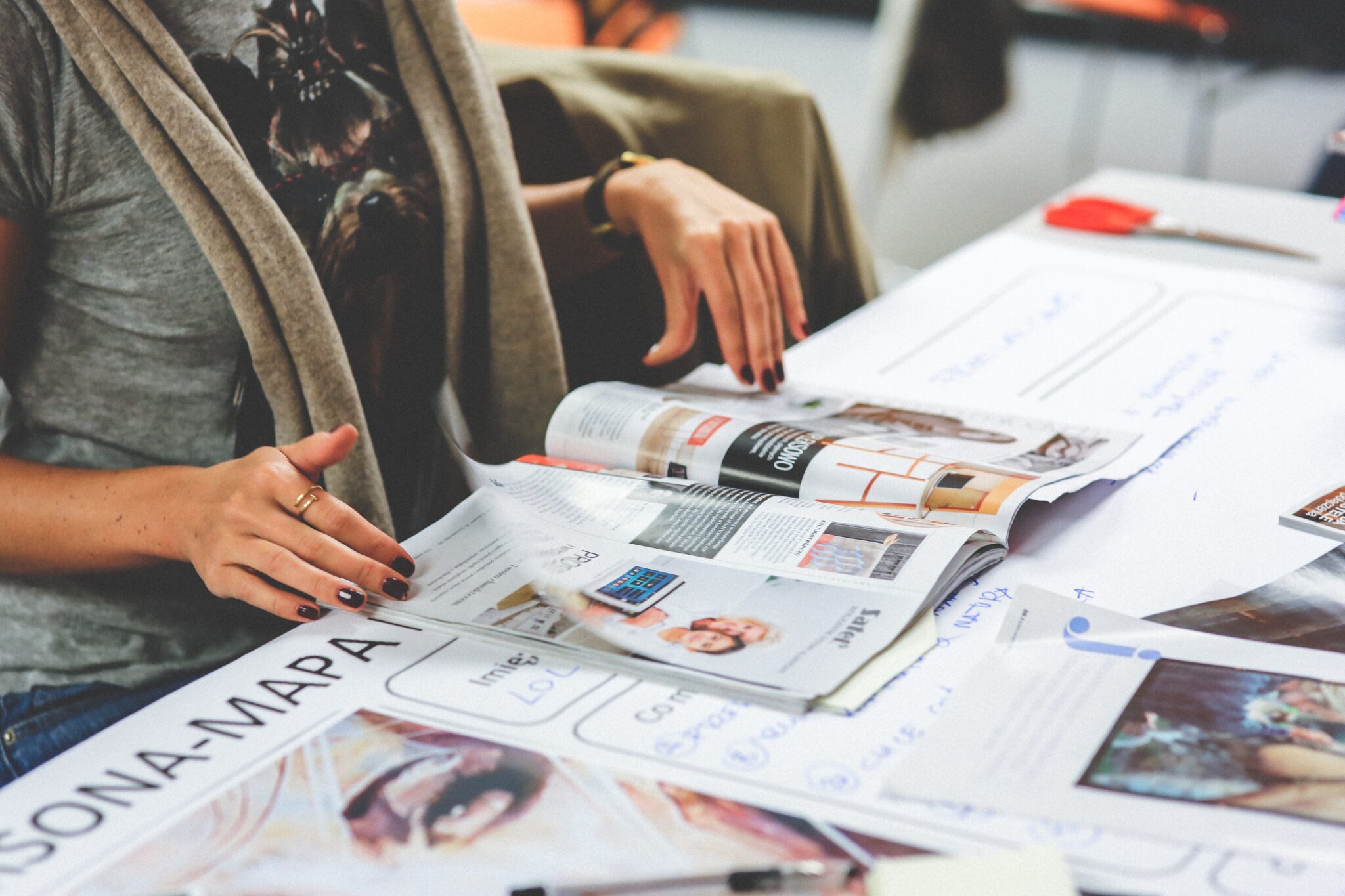 woman-s-hands-with-magazine